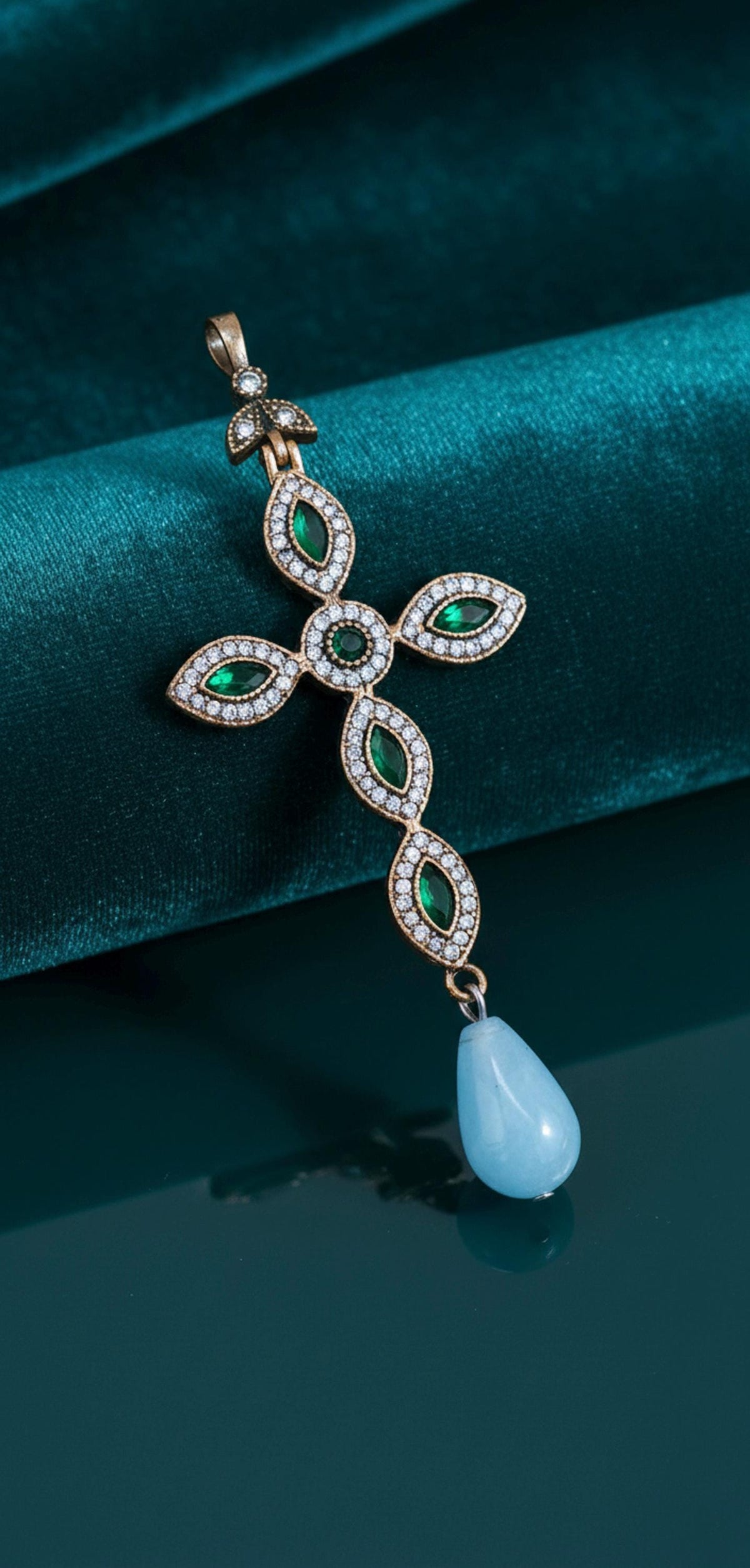 925 gold-plated silver cross with cubic zirconia and a teardrop-shaped light blue stone