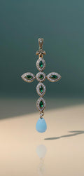 925 gold-plated silver cross with cubic zirconia and a teardrop-shaped light blue stone