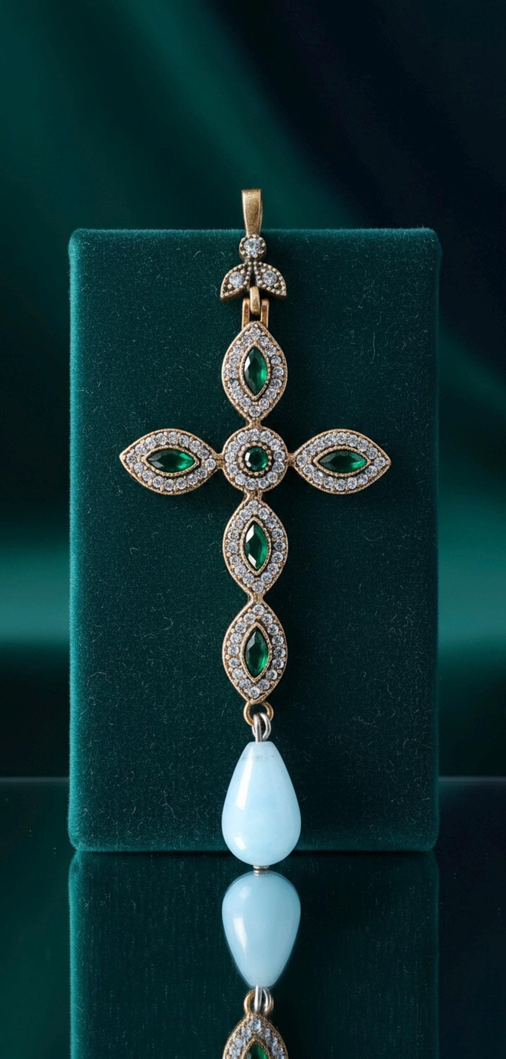 925 gold-plated silver cross with cubic zirconia and a teardrop-shaped light blue stone