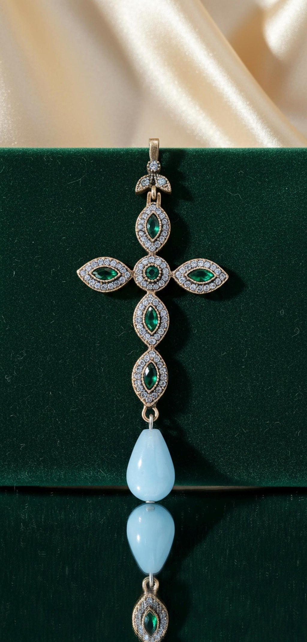 925 gold-plated silver cross with cubic zirconia and a teardrop-shaped light blue stone
