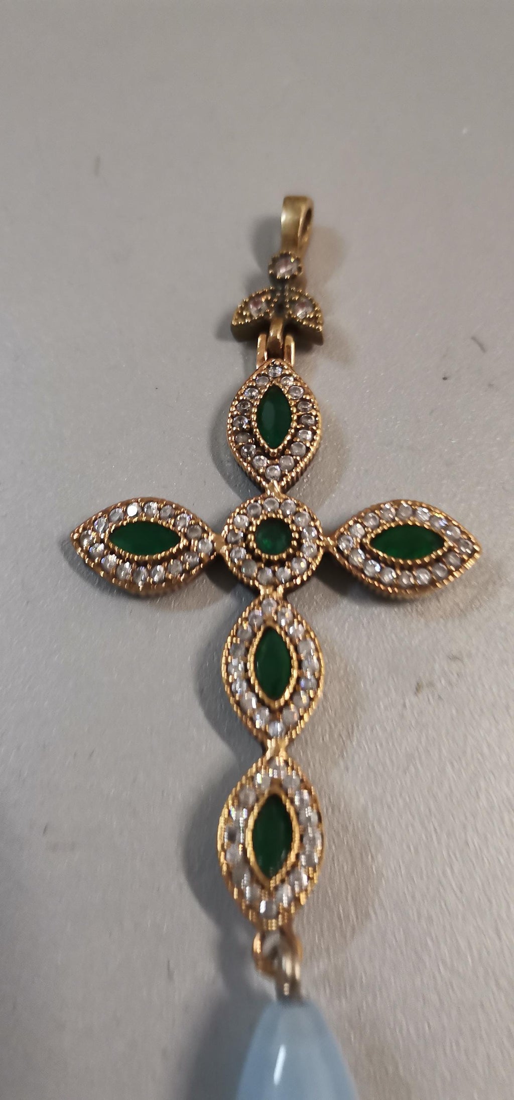 925 gold-plated silver cross with cubic zirconia and a teardrop-shaped light blue stone